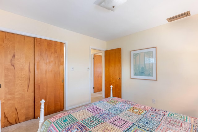 bedroom featuring visible vents, carpet, and a closet