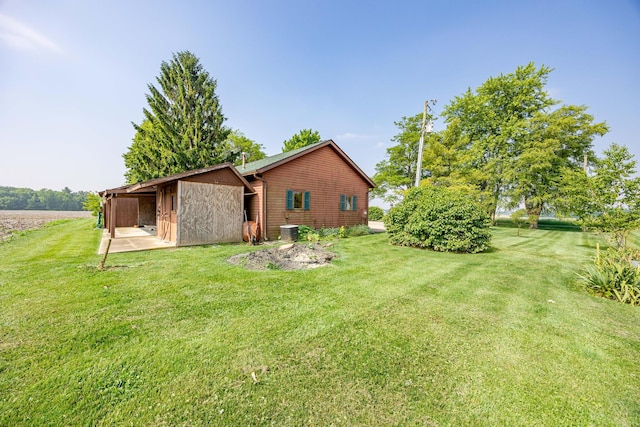 8339 Hite Rd, West Liberty, OH 43357 - rear view of property featuring a lawn and cooling unit