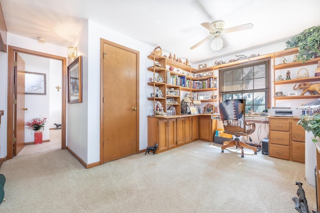 8339 Hite Rd, West Liberty, OH 43357 - office area featuring light carpet, ceiling fan, built in desk, and baseboards