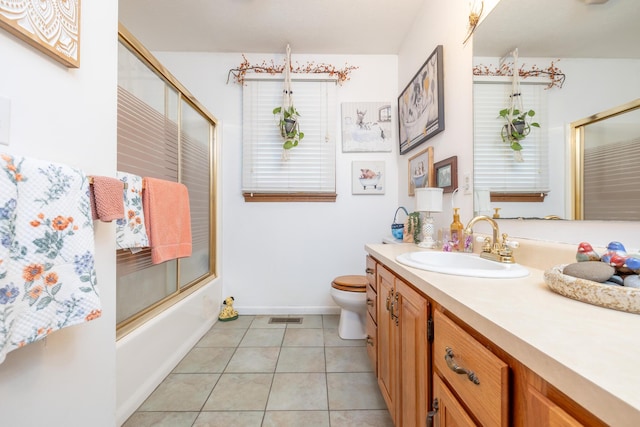 8339 Hite Rd, West Liberty, OH 43357 - bathroom featuring vanity, toilet, shower / bath combination with glass door, tile patterned floors, and baseboards