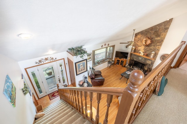 8339 Hite Rd, West Liberty, OH 43357 - stairs featuring a ceiling fan, vaulted ceiling, wood finished floors, and a fireplace
