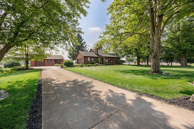 8339 Hite Rd, West Liberty, OH 43357 - view of front facade with a front yard, driveway, and a chimney