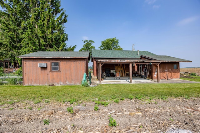 8339 Hite Rd, West Liberty, OH 43357 - rear view of property with a patio area, a lawn, and a wall mounted air conditioner