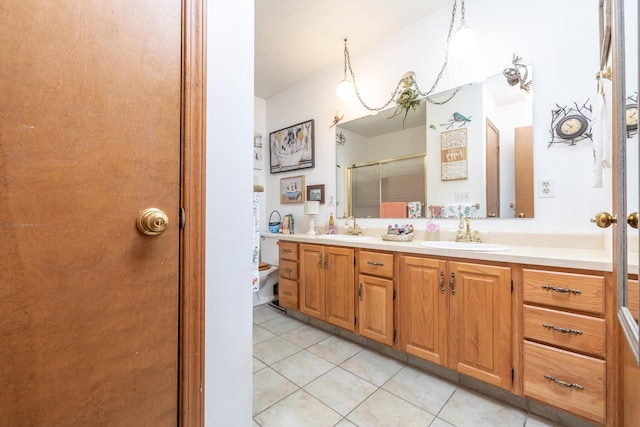 8339 Hite Rd, West Liberty, OH 43357 - bathroom with double vanity, tile patterned floors, a shower with shower door, and toilet