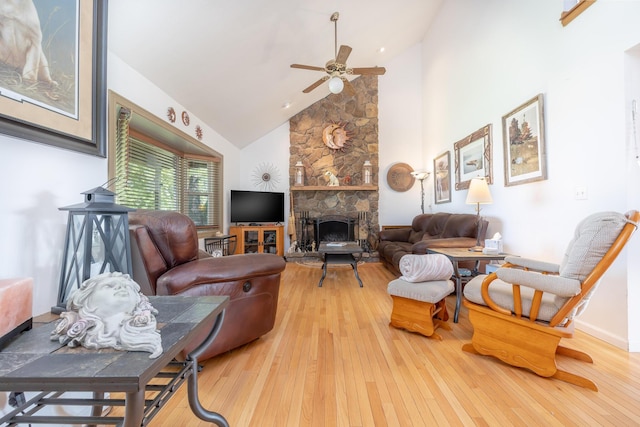 8339 Hite Rd, West Liberty, OH 43357 - living room featuring wood-type flooring, a ceiling fan, high vaulted ceiling, a stone fireplace, and baseboards