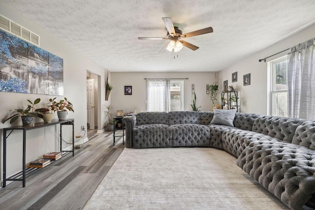 2909 W Barnhill Pl, Xenia, OH 45385 - living room featuring wood finished floors, ceiling fan, and a textured ceiling