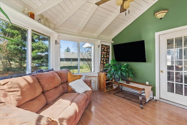 sunroom with a ceiling fan, wood ceiling, and vaulted ceiling with beams