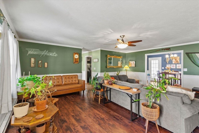 living room featuring a wainscoted wall, wood finished floors, a ceiling fan, and ornamental molding