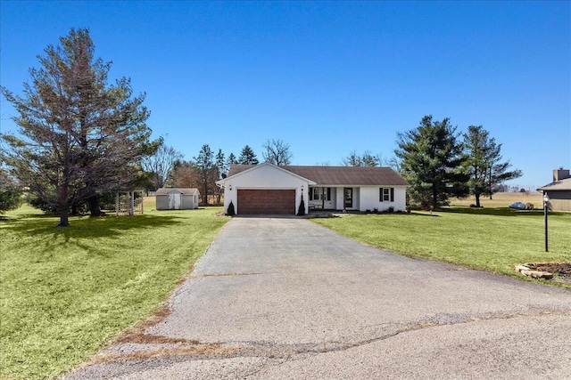 single story home with aphalt driveway, an attached garage, and a front lawn