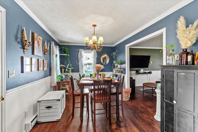 dining area featuring dark wood-style flooring, a chandelier, and wainscoting