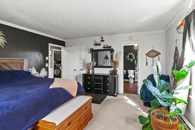 bedroom with light carpet, washer / dryer, ensuite bathroom, and ornamental molding