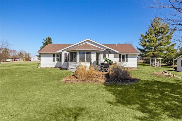 back of house featuring a lawn and a sunroom