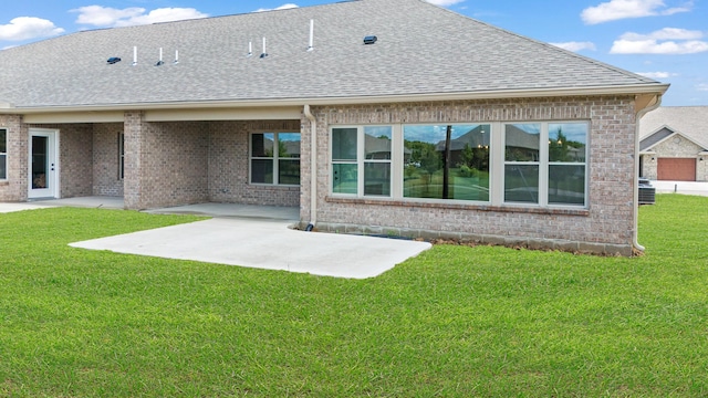 1160 Waterloo St, Troy, OH 45373 - rear view of property featuring a shingled roof, brick siding, a patio area, and a lawn