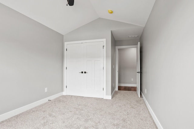 1160 Waterloo St, Troy, OH 45373 - unfurnished bedroom featuring carpet flooring, vaulted ceiling, a closet, and ceiling fan
