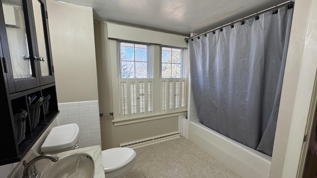 full bathroom with tile walls, toilet, baseboard heating, shower / tub combo, and a sink