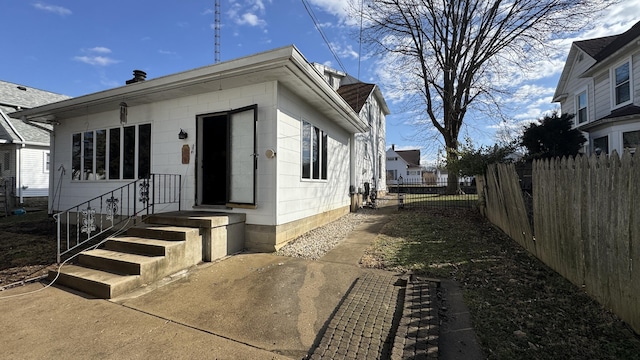 view of home's exterior with fence