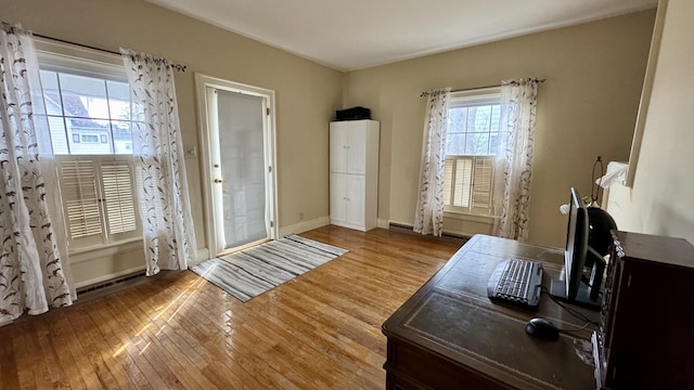 home office with wood finished floors and baseboards