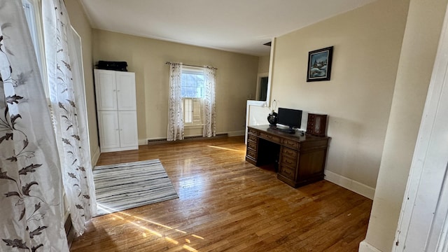 office area featuring light wood finished floors and baseboards