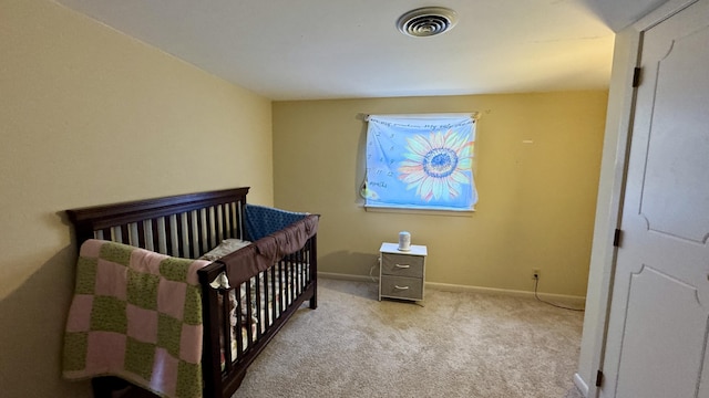 carpeted bedroom with a nursery area, visible vents, and baseboards