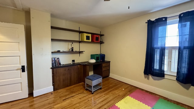 office area featuring baseboards and light wood-style floors