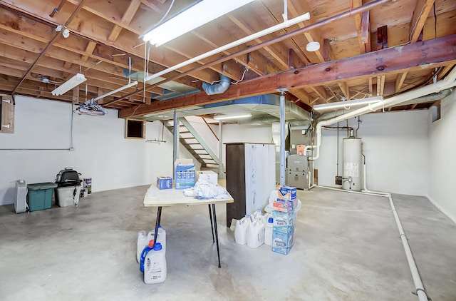 unfinished below grade area with stairway, gas water heater, and heating unit