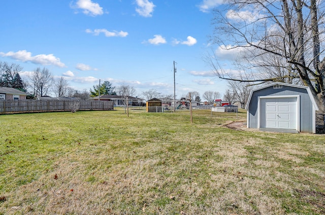 view of yard featuring a storage unit, an outdoor structure, and fence