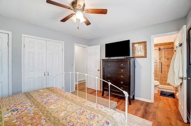 bedroom with a closet, a ceiling fan, connected bathroom, wood finished floors, and baseboards