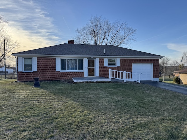 single story home with a garage and a yard