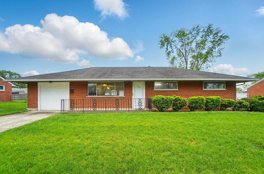 2100 Mattis Dr, Dayton, OH 45449 - ranch-style house with a garage, a front yard, concrete driveway, and brick siding