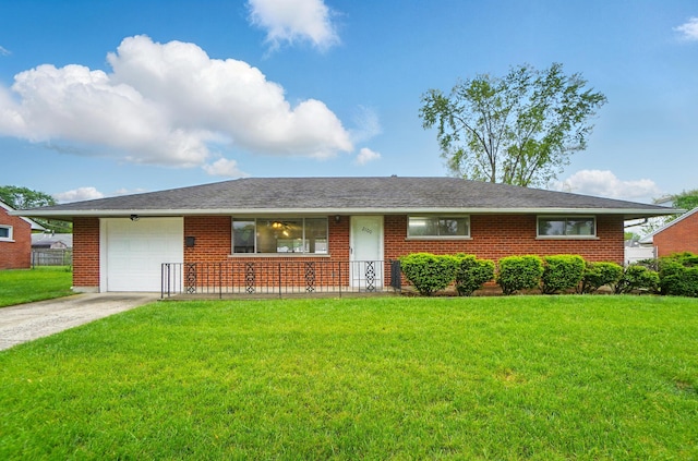 2100 Mattis Dr, Dayton, OH 45449 - ranch-style house with a garage, a front yard, concrete driveway, and brick siding