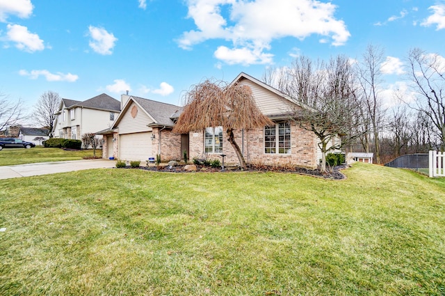 view of front facade featuring an attached garage, fence, concrete driveway, and a front yard