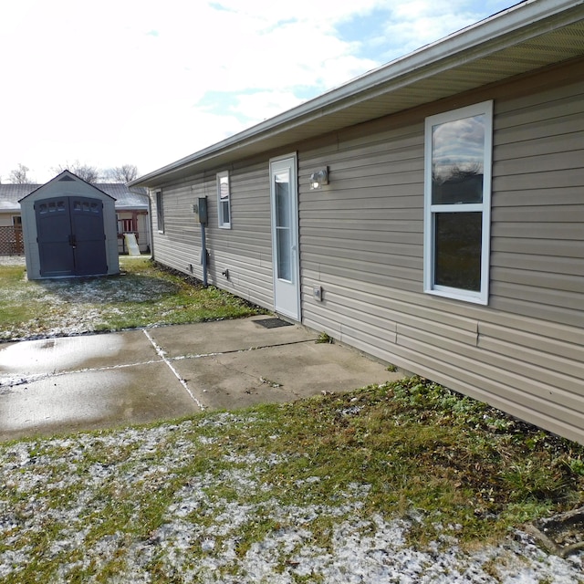 3210 Red Feather Rd, Sidney, OH 45365 - back of property with a storage shed, a patio area, and an outdoor structure