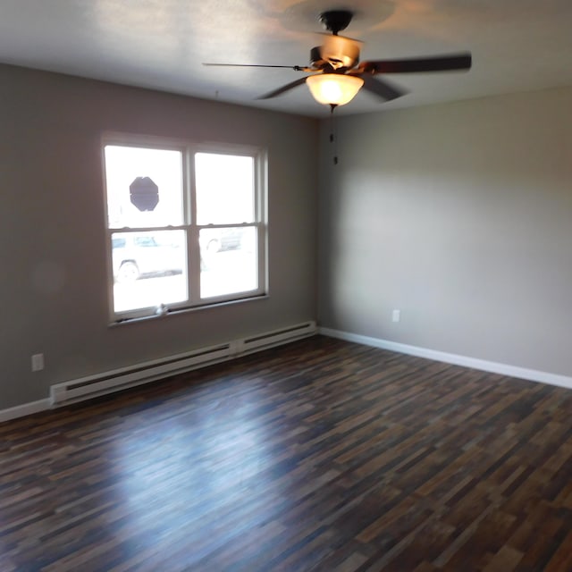 3210 Red Feather Rd, Sidney, OH 45365 - unfurnished room featuring a baseboard heating unit, a ceiling fan, baseboards, and dark wood-type flooring