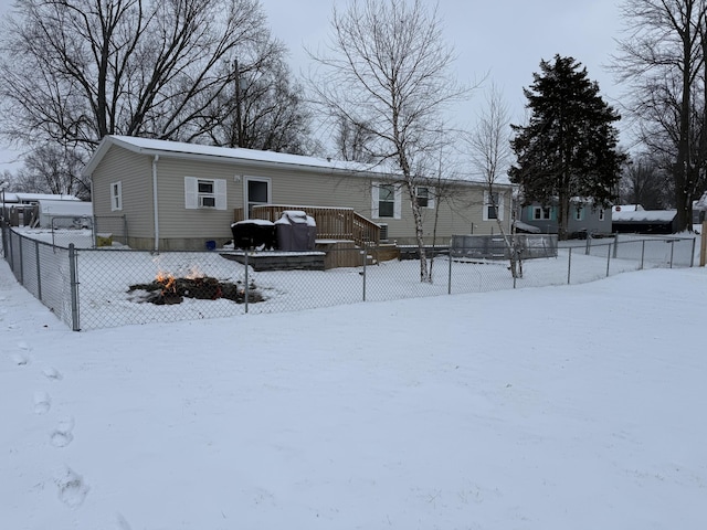 snow covered property with fence