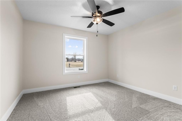 empty room featuring carpet floors and ceiling fan