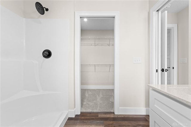 bathroom with vanity, wood-type flooring, and walk in shower