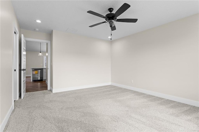 spare room featuring carpet floors and ceiling fan