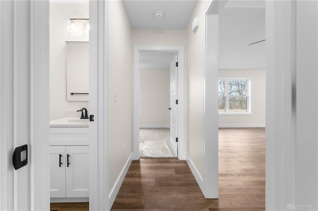 hall with sink and dark hardwood / wood-style floors