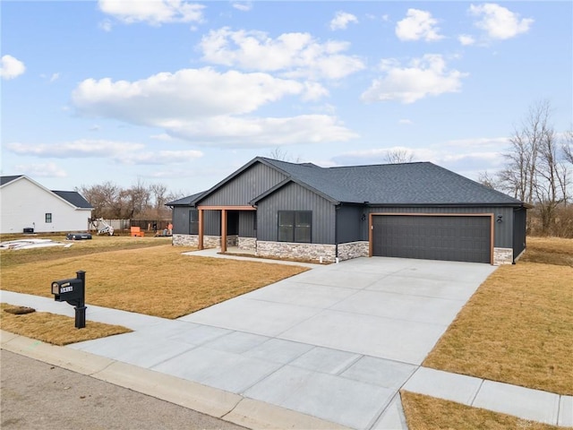 view of front of property with a garage, covered porch, and a front yard