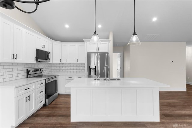 kitchen with sink, hanging light fixtures, stainless steel appliances, a kitchen island with sink, and white cabinets