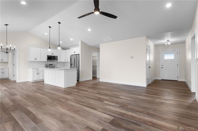 kitchen featuring hanging light fixtures, a center island, white cabinets, and appliances with stainless steel finishes