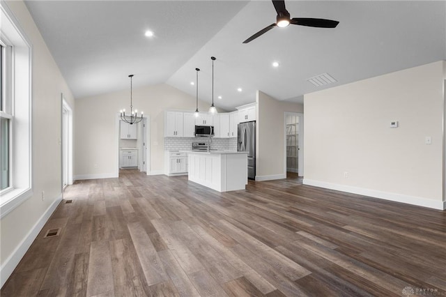 unfurnished living room with lofted ceiling, hardwood / wood-style floors, and ceiling fan with notable chandelier