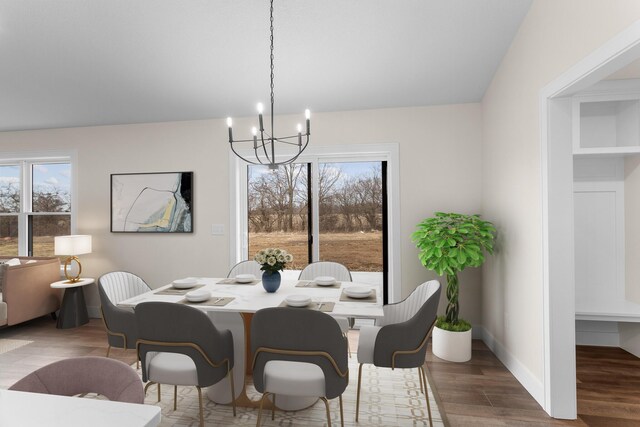 dining space with a chandelier and wood finished floors