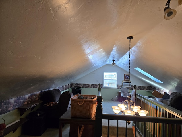 interior space featuring vaulted ceiling with skylight and carpet floors