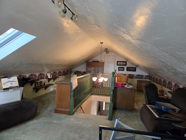 carpeted office featuring rail lighting, lofted ceiling, and a textured ceiling