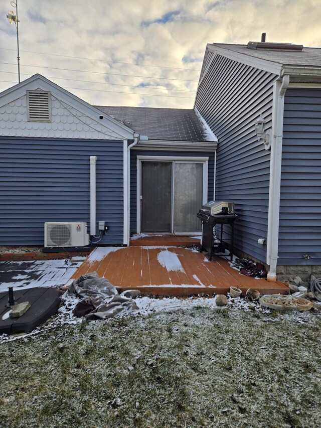 exterior space with a wooden deck and ac unit