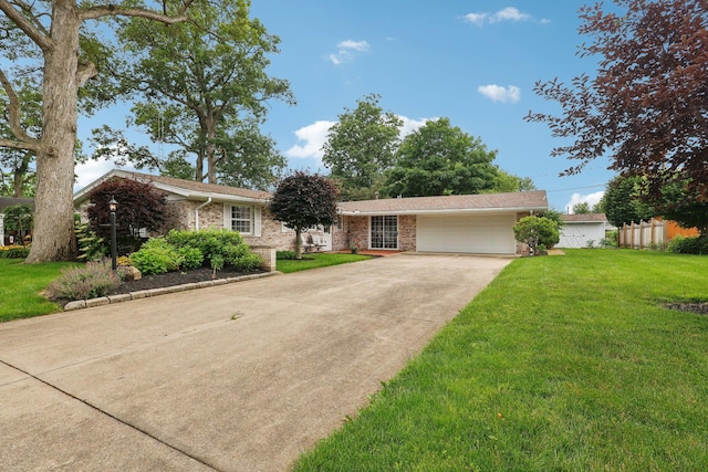 282 Hickory Dr, Greenville, OH 45331 - ranch-style house featuring an attached garage, driveway, a front lawn, and brick siding