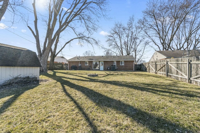 exterior space with an outbuilding, a storage shed, and a fenced backyard