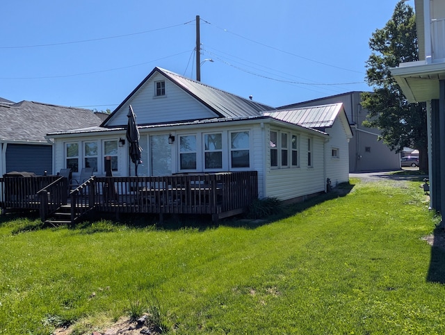 127 Brads Way, Russells Point, OH 43348 - view of front of home with a wooden deck, a front lawn, and a metal roof