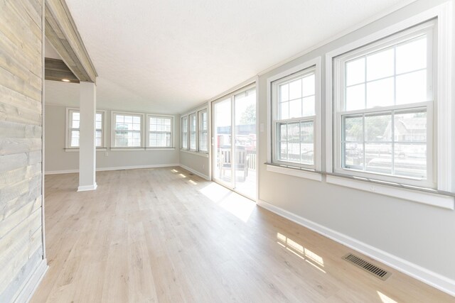 127 Brads Way, Russells Point, OH 43348 - unfurnished sunroom featuring baseboards and wood finished floors
